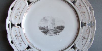 Plate with image of White Terrace Eruption, date unknown, maker unknown, Rotorua Museum Te Whare Taonga o Te Arawa (2011.63.3)